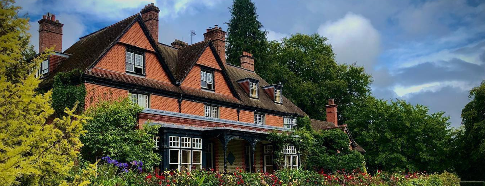 the tearooms surrounded by flowers and trees on a sunny day